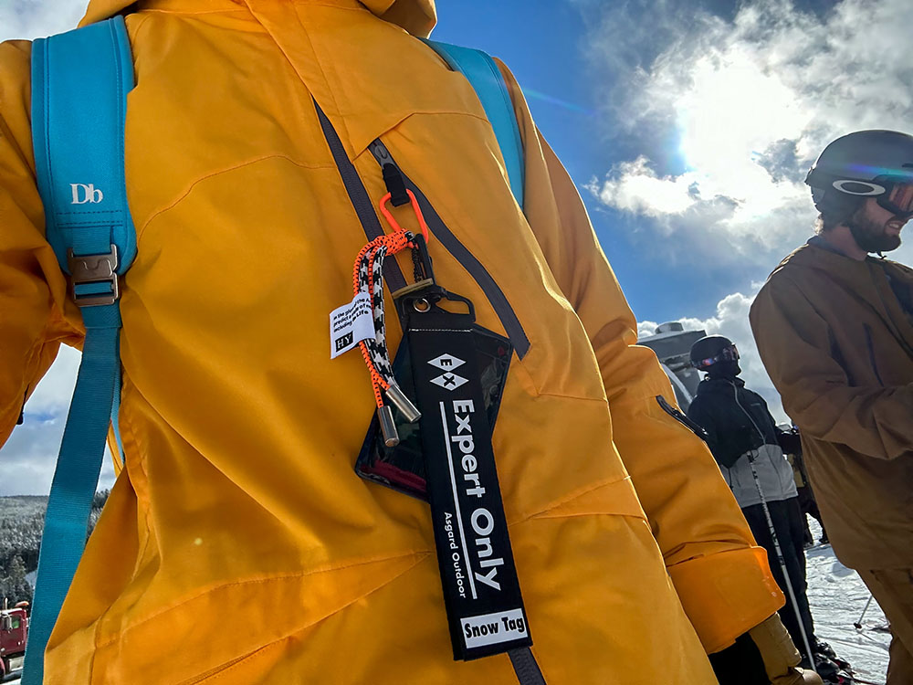 A skier wearing a yellow jacket with an 