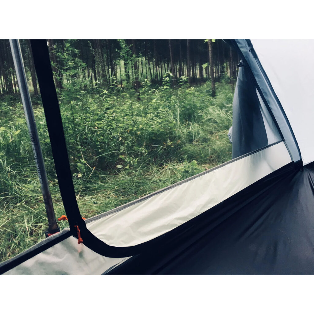 Inside view of a tent with forest outside