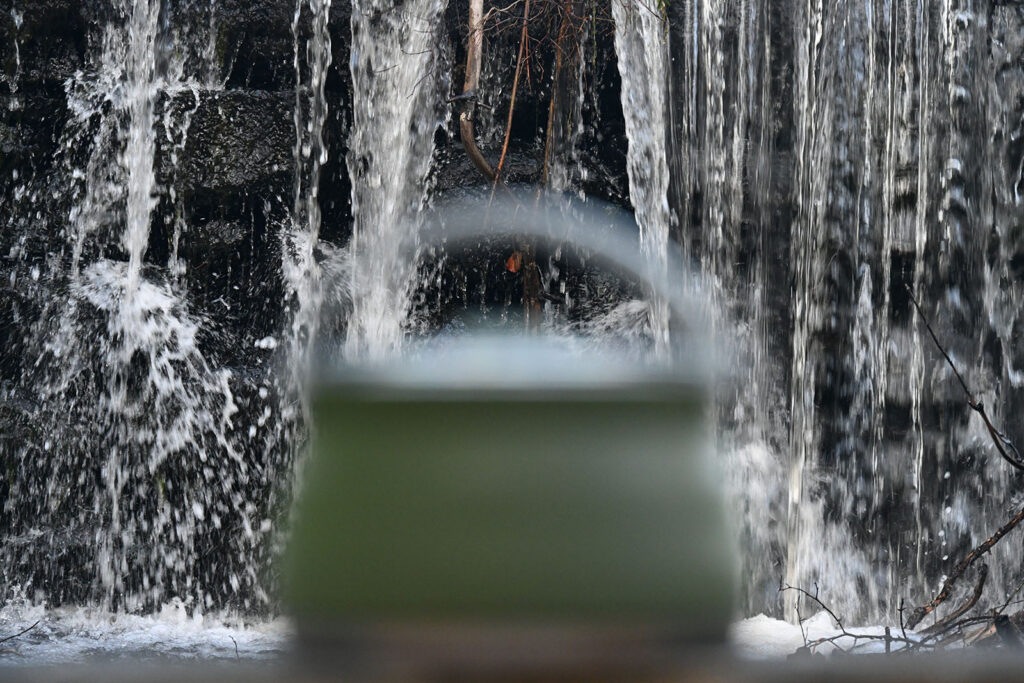 Folding Camping pot in front of a cascading waterfall