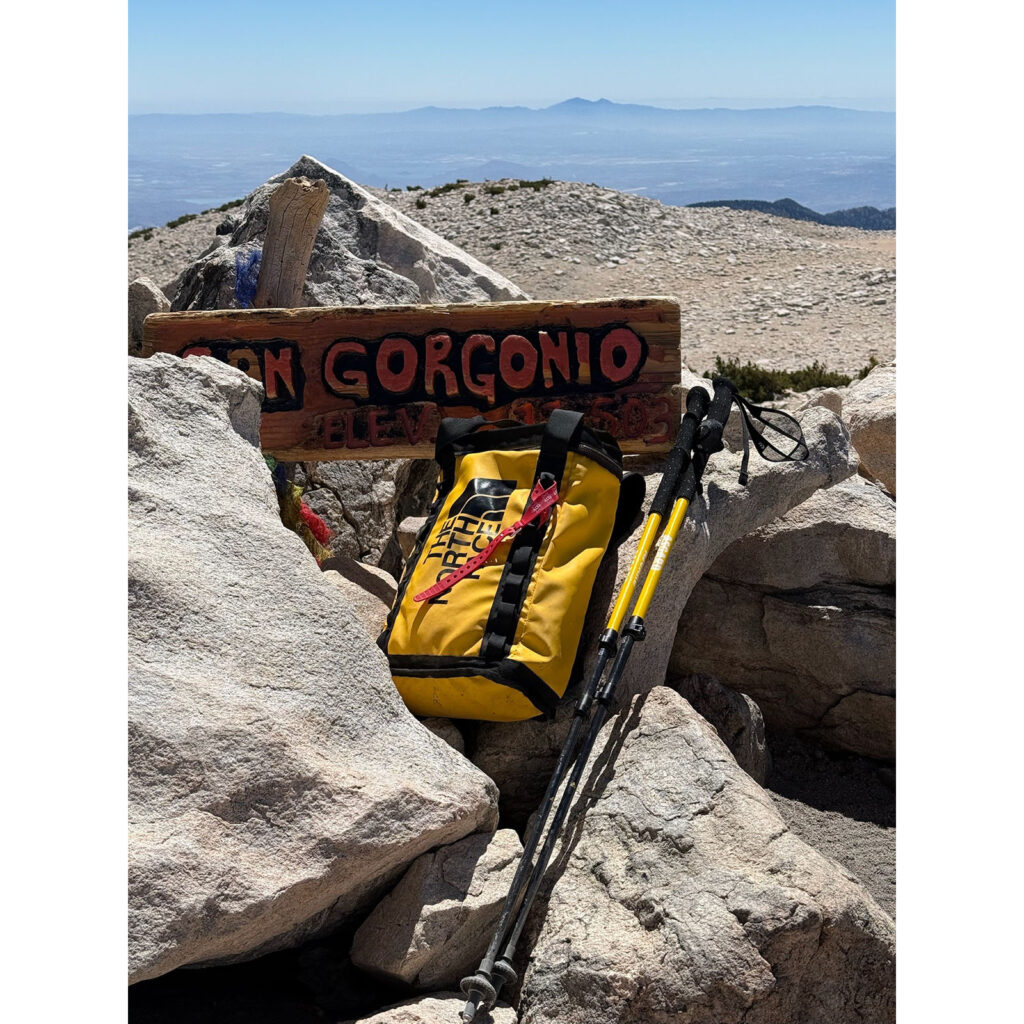 Asgard Hydrogen Poles 2.0 and yellow backpack beside Mt. San Gorgonio summit sign
