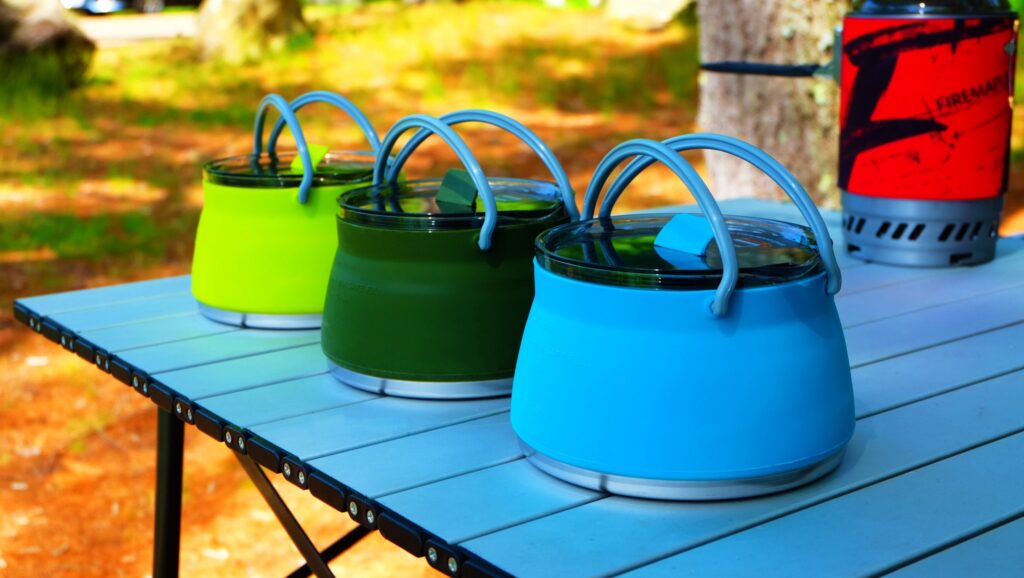 Asgard collapsible camping pots in green, blue, and yellow