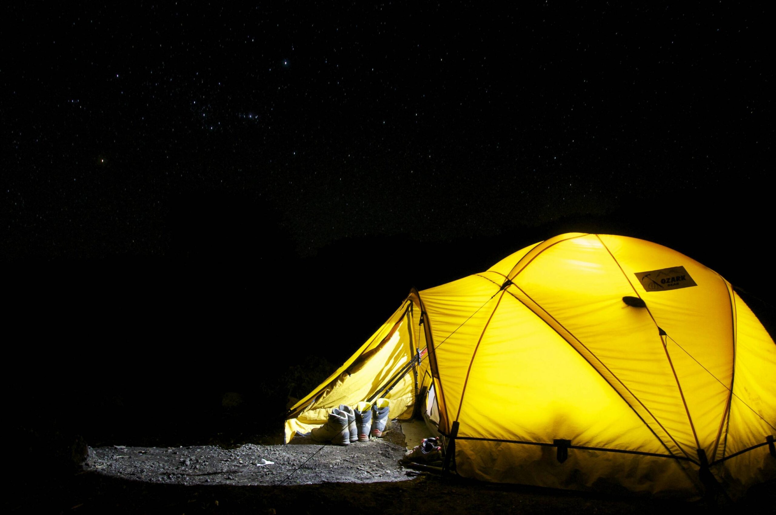 yellow-tent-under-starry-night Photo by Pixabay