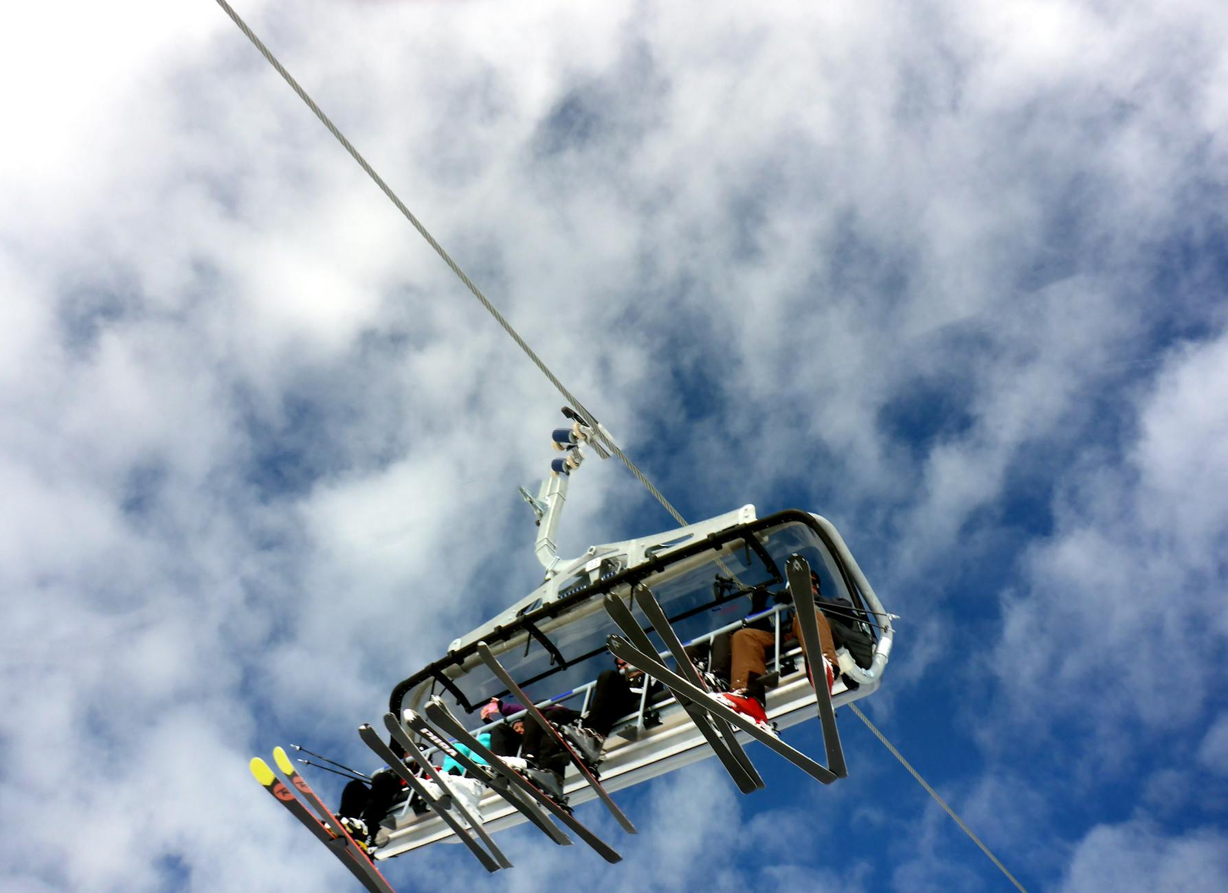 Skiers on a chairlift at a snowy resort -photo-by-pexels