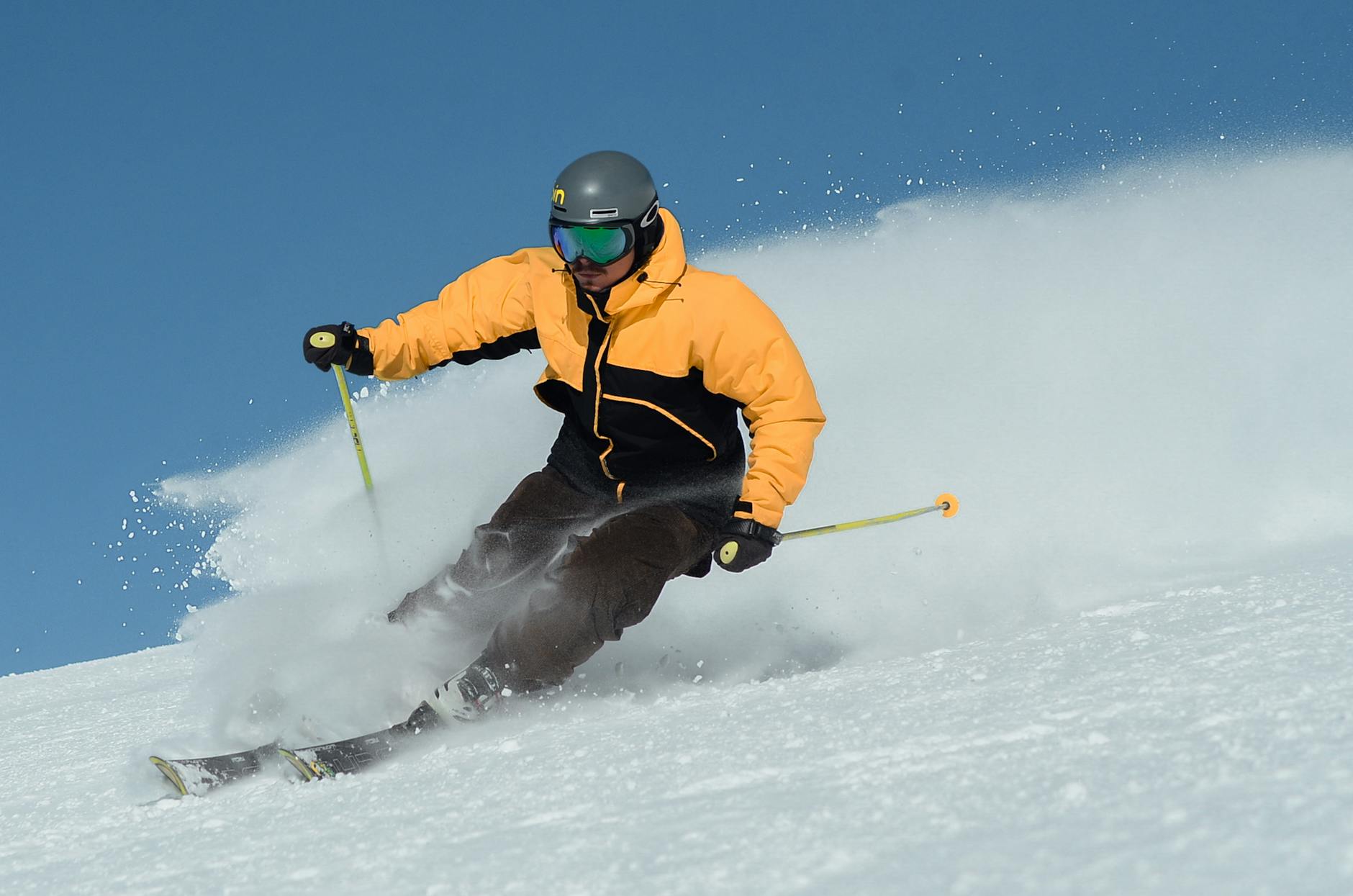 Skier adjusting ski helmet to check fit and comfort before heading onto the slopes-photo-by-pexels