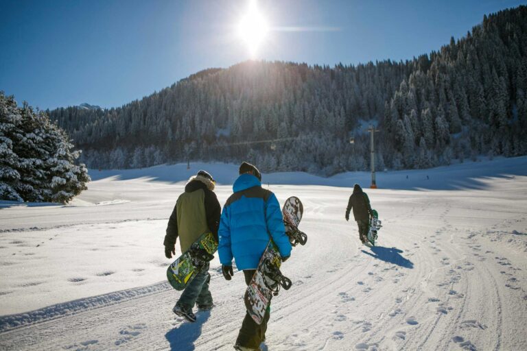 three-person carrying-snowboards Photo by Visit Almaty