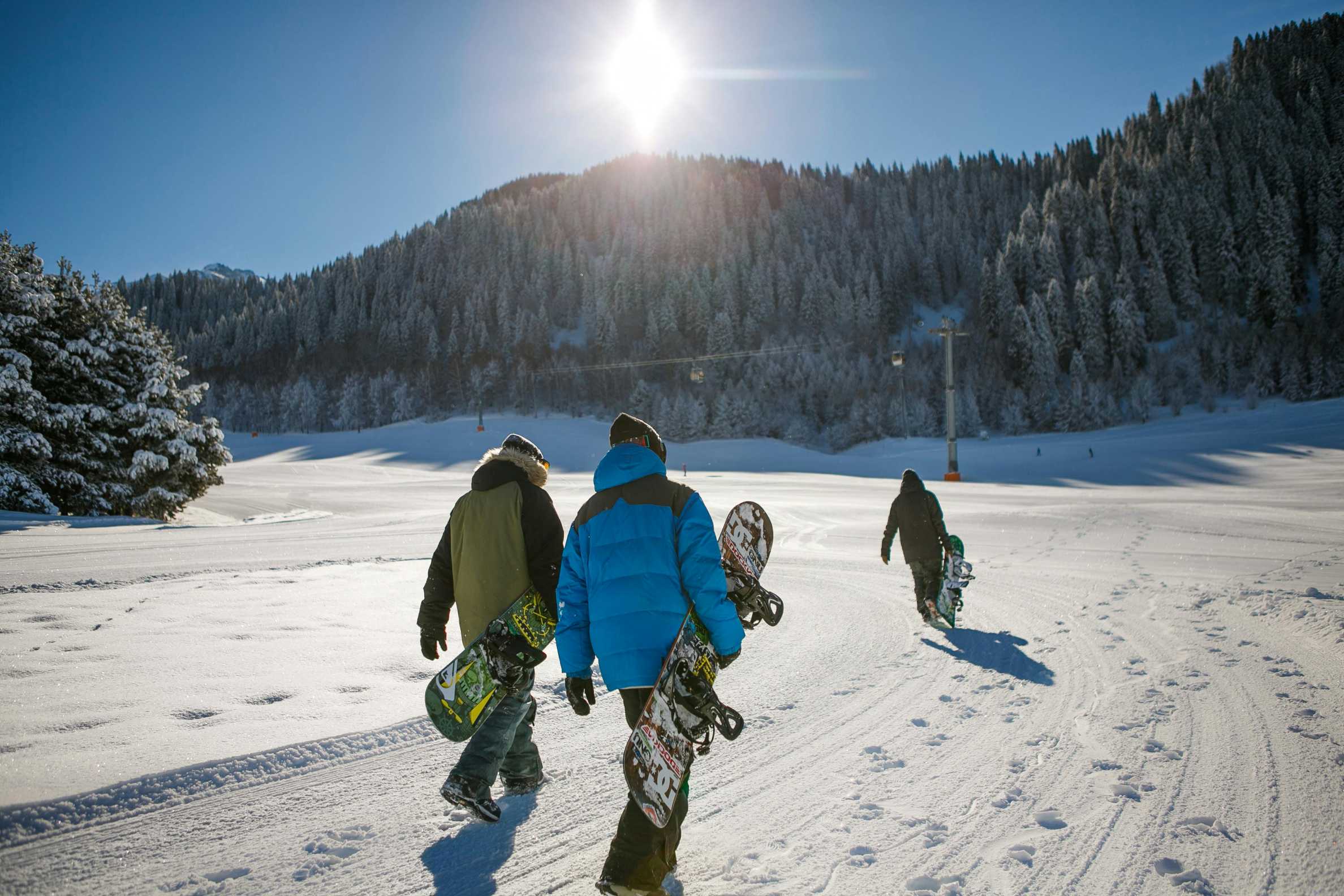 three-person carrying-snowboards Photo by Visit Almaty