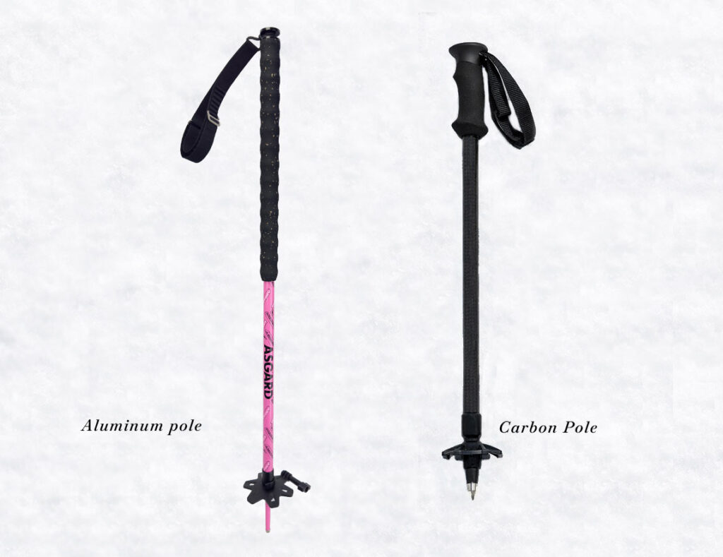 Carbon and aluminum ski poles side by side on snow showing differences in construction.