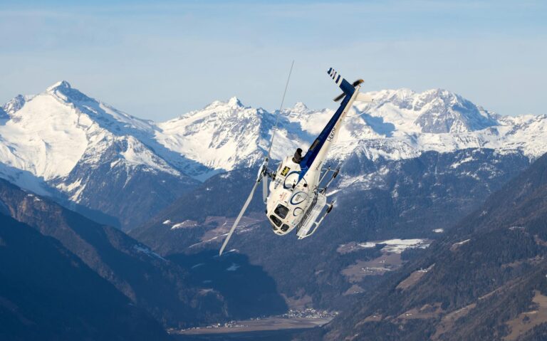 Helicopter on a snowy landing pad with Wasatch peaks in the background at the Snowbird heliport.-photo-by-pexels