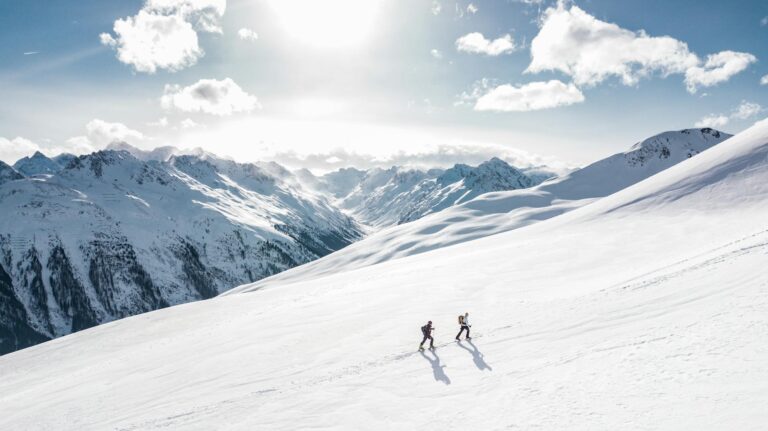Wide view of Sunrise Ski Resort on Sunrise Peak with skiers and windy clouds-photo-by-pexels