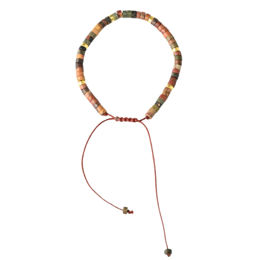 Asgard Terra ID earth-tone mineral bracelet with slim disc beads, metallic accents, and adjustable brown sliding cord on plain background.