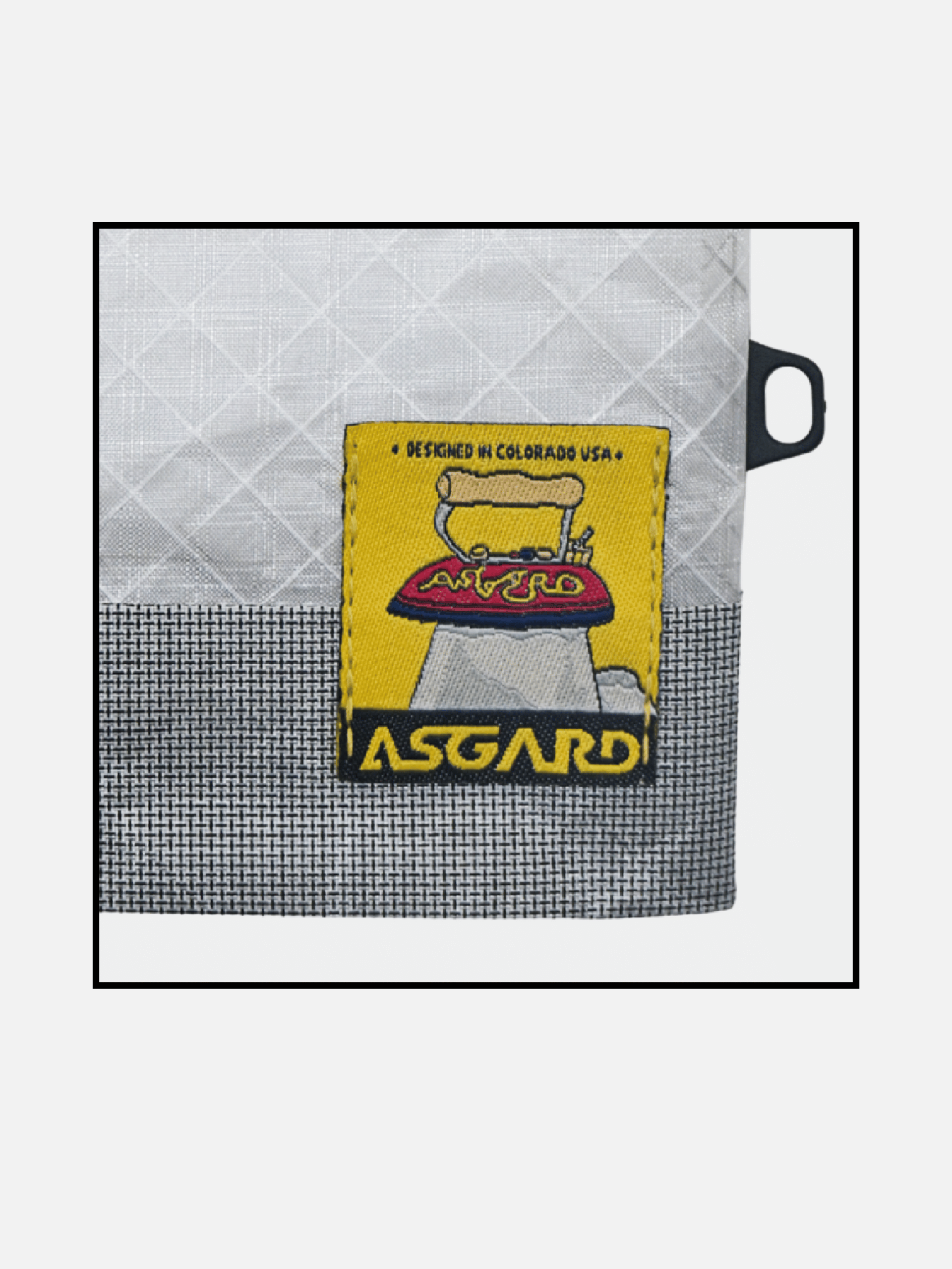 Yellow Asgard logo patch stitched onto the mini tote’s contrasting fabric panels.