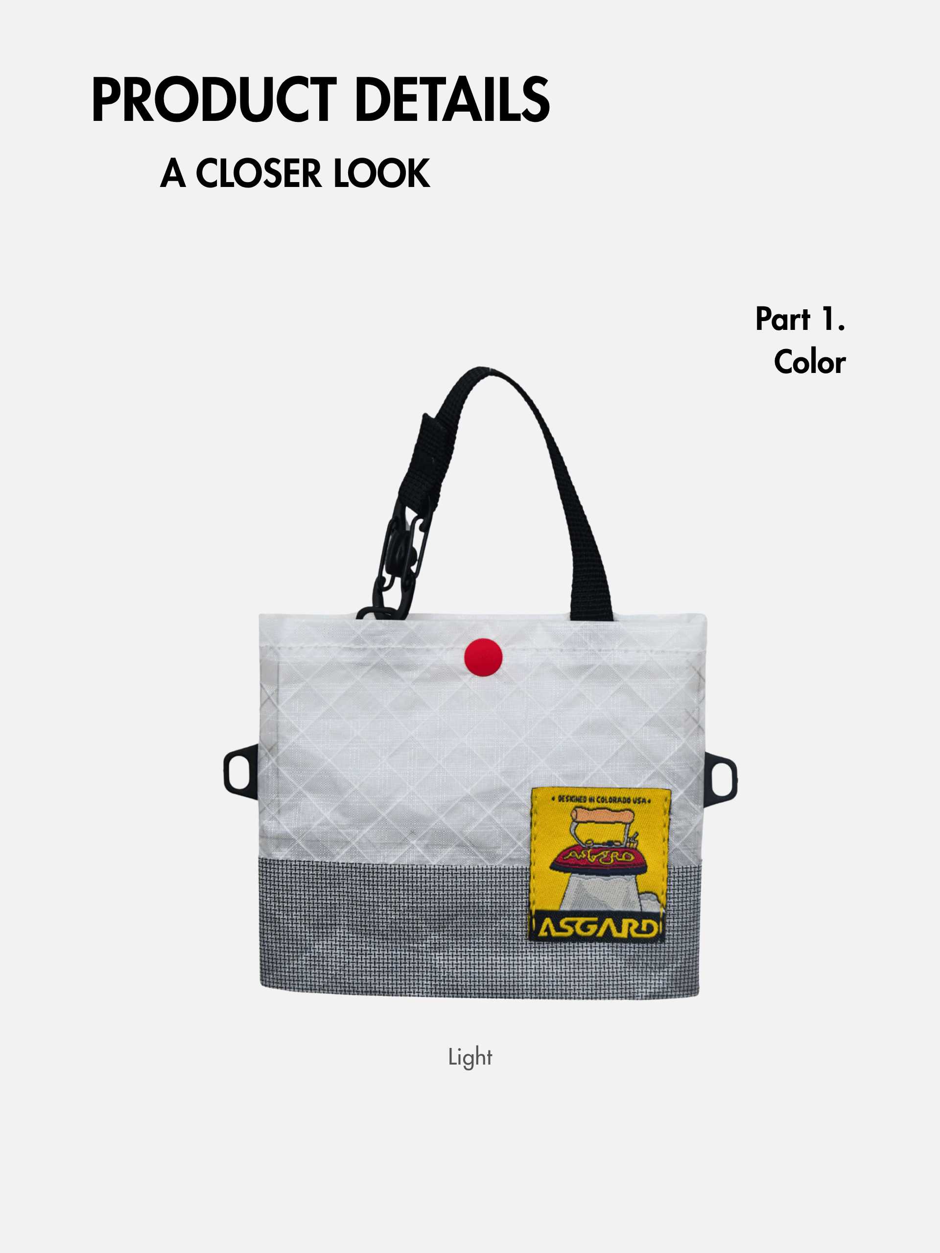 Front detail view of the light gray mini tote with black handles, dark lower fabric and a yellow Asgard patch.