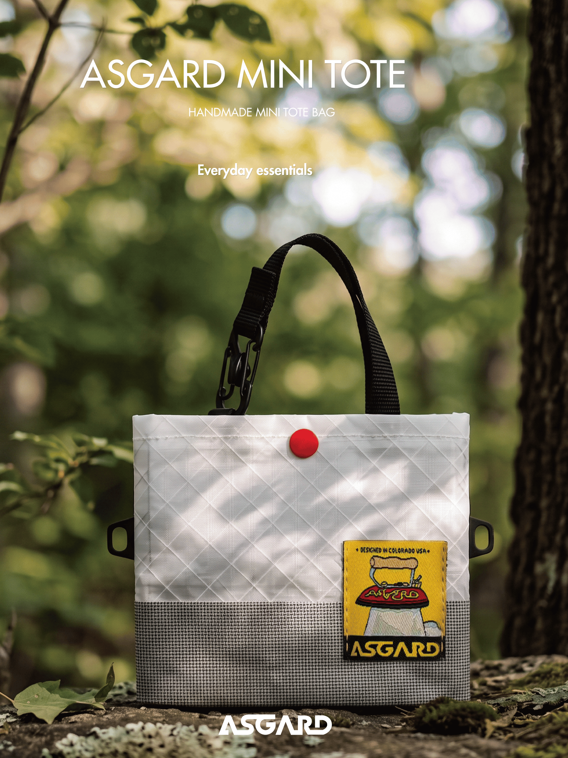 Light gray Asgard mini tote standing on a rock with green foliage in the background.