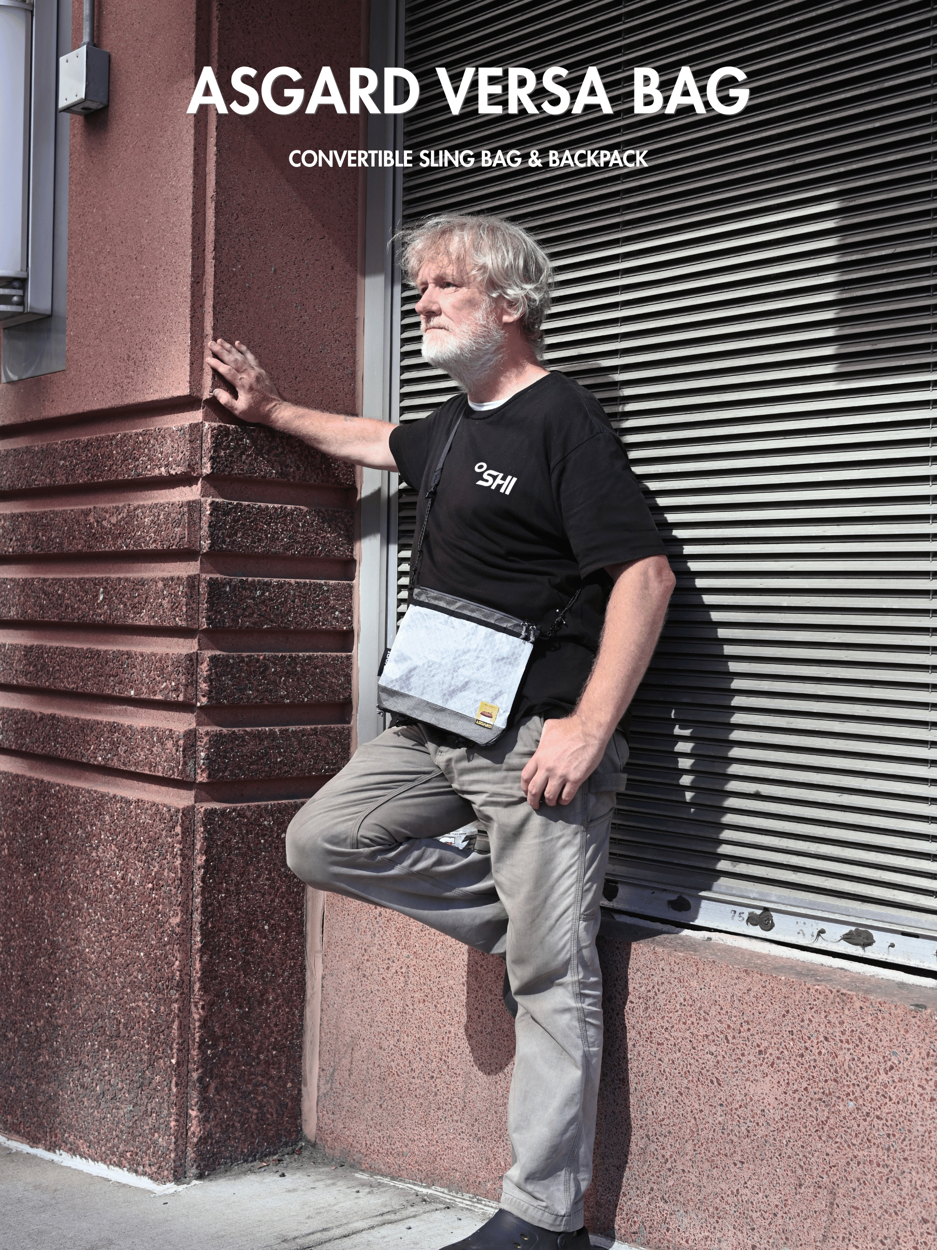Man wearing the white Asgard Versa Bag crossbody beside a city building, with Convertible Sling Bag & Backpack text.