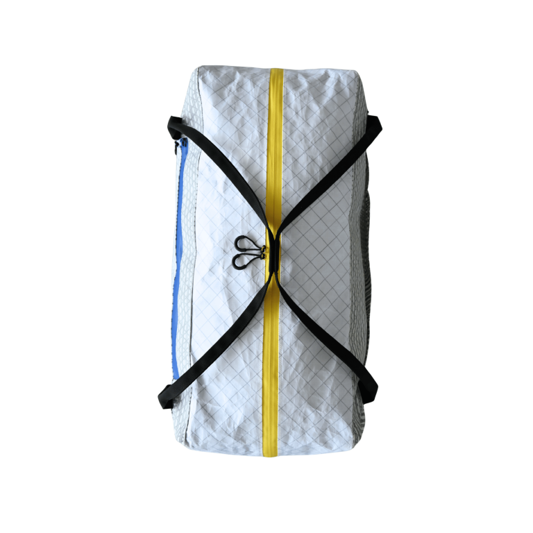 Top view of the Asgard Duffel Bag showing black carry handles across a yellow main zipper with two loop pulls.