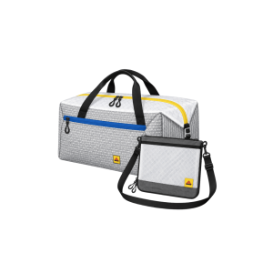 White and gray duffle bag with yellow and blue zippers beside a matching sling bag with a black strap.